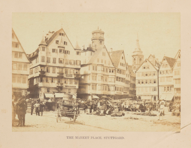 Old black-and-white photograph of a crowded market square in Stuttgart, Germany, with multi-story buildings, pedestrians, horse-drawn carts, and scattered goods; handwritten text along the bottom edge.