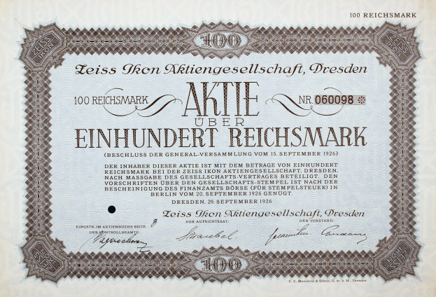 Ein altes deutsches Aktienzertifikat mit schwarzem Rand und der Inschrift "Aktie über Einhundert Reichmark"