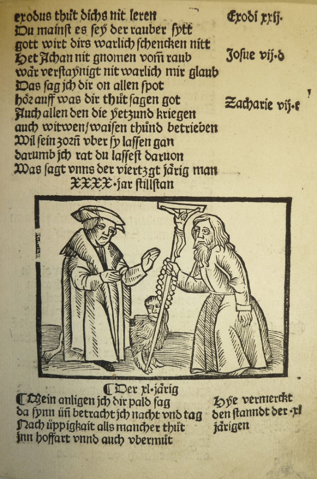 Ein Blatt mit gedrucktem Text in einer fremden Sprache, mit zwei Männern im Hintergrund, möglicherweise aus einem Lehrbuch.